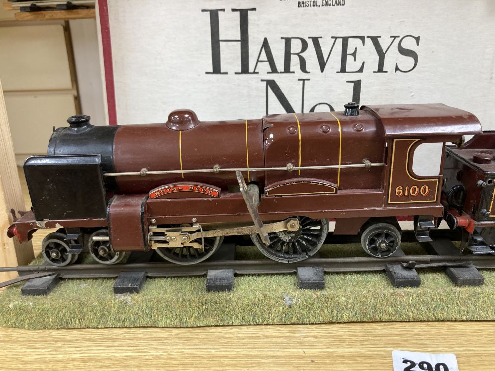 A Hornby O gauge Royal Scot 6100 clockwork locomotive and tender, two no. 31 coaches and a Flat truck, and a quantity of track